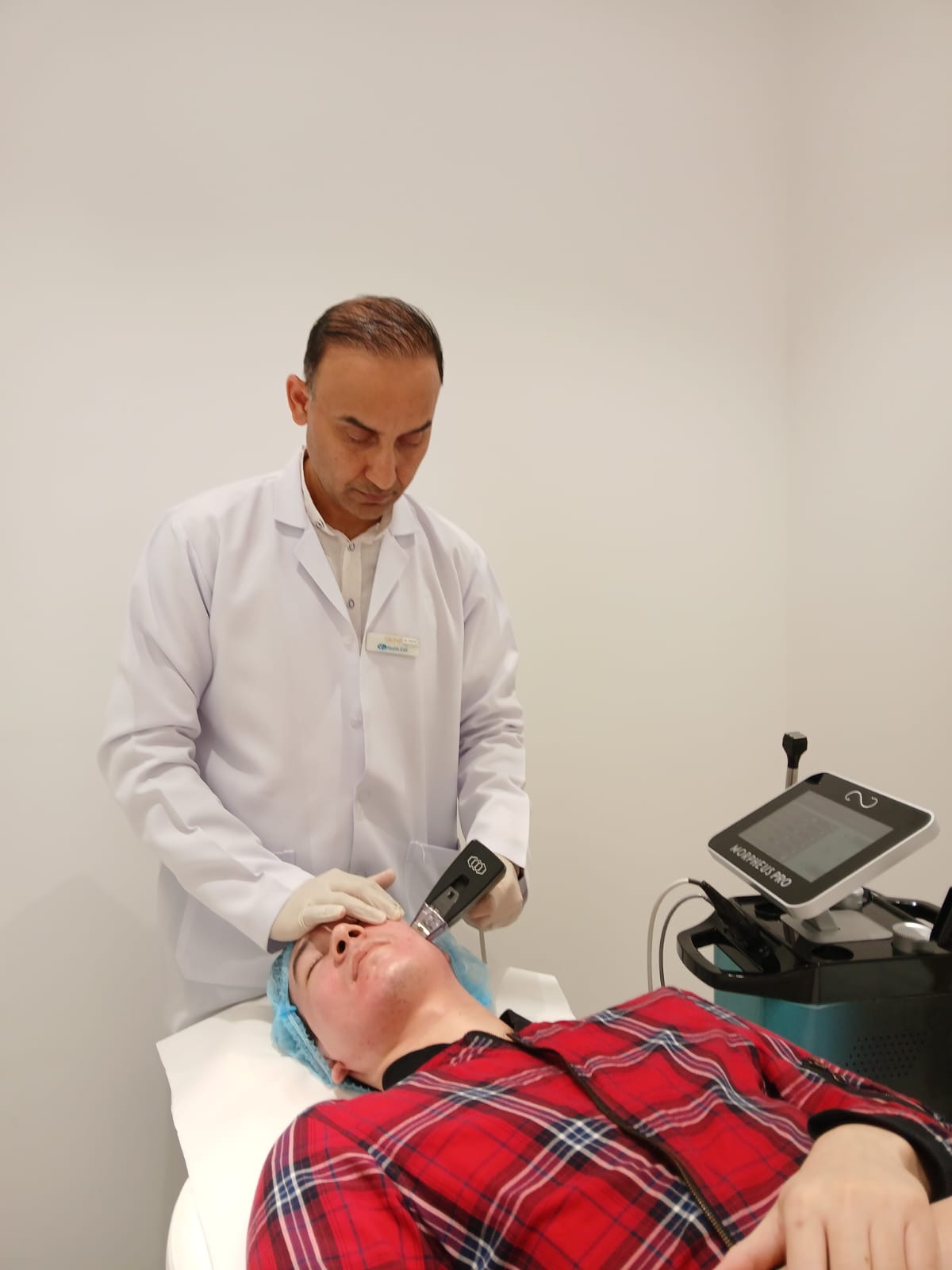 Dr. Zaheer Abbas treating a patient in a clinical setting