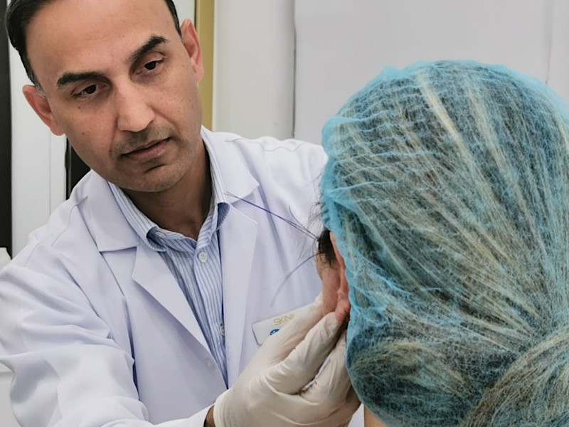 Dr. Zaheer Abbas examining a patient in the clinic